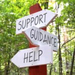 A photo of a sign saying support, guidance and help, representing pet loss and pet grief support groups.