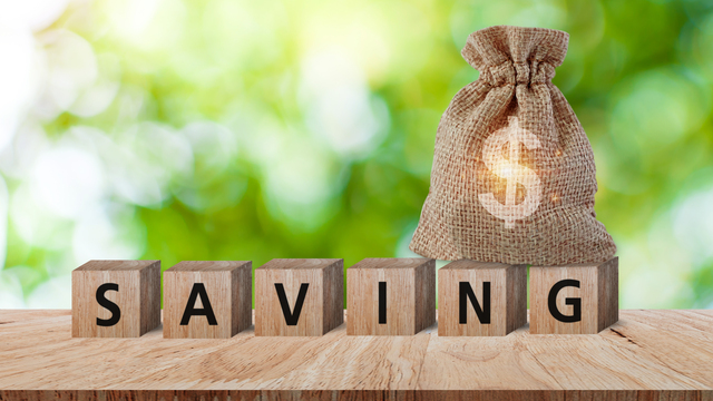 Wood blocks spelling the word saving, depicting the savings when buying discount caskets online.