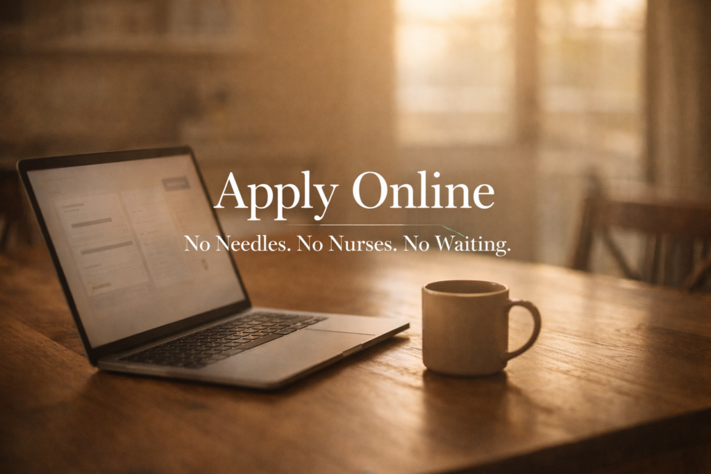 Laptop on kitchen table with coffee showing online life insurance application process, warm natural lighting