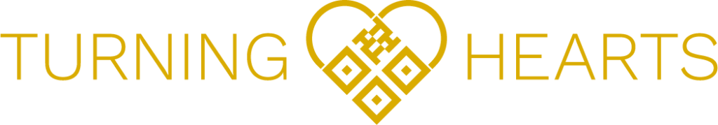 Turning Hearts logo in gold on black background featuring a heart with QR code design